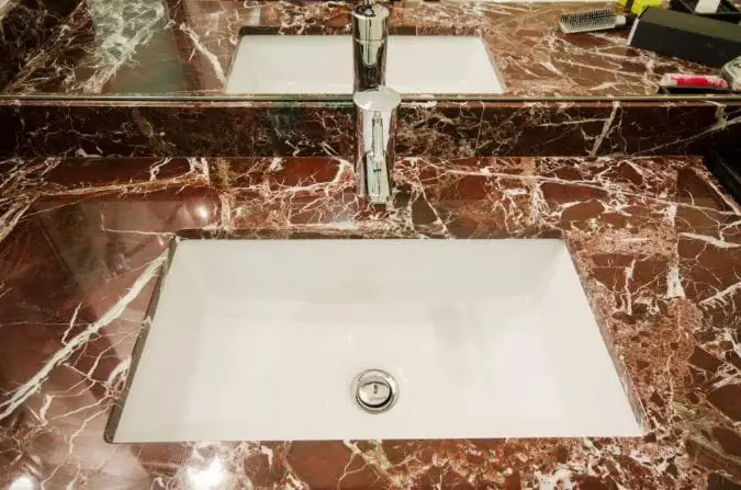 unique red polished marble bathroom countertop with white undermount sink