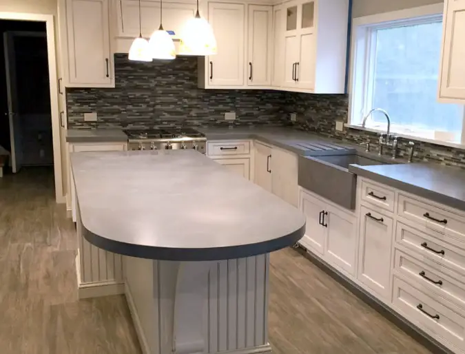 https://www.countertopspecialty.com/images/curved-concrete-countertop-kitchen-island-675.jpg?ezimgfmt=rs:392x299/rscb45/ngcb45/notWebP